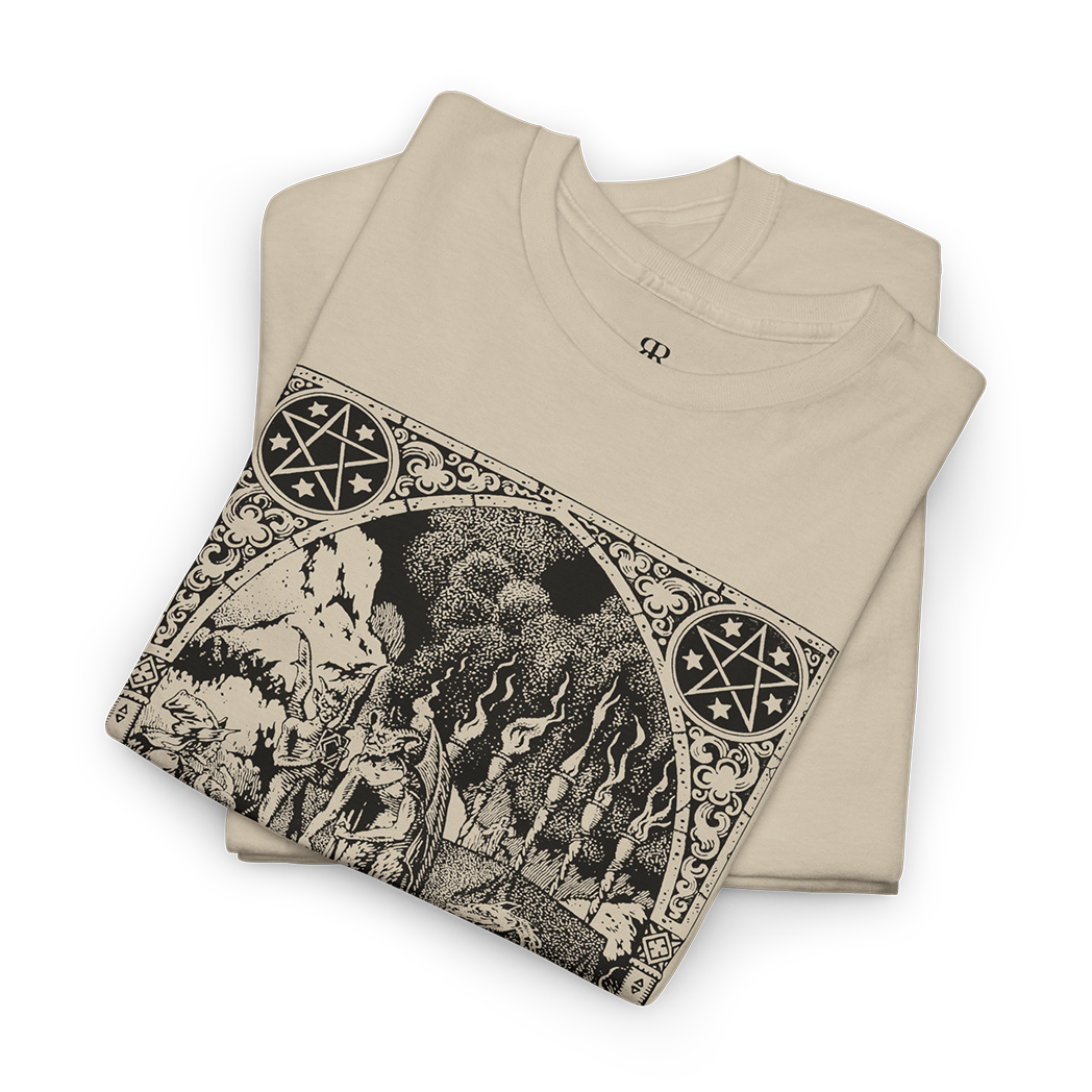 This image displays a beige t-shirt featuring a detailed and artistic print centered around the themes of witches and demons. 