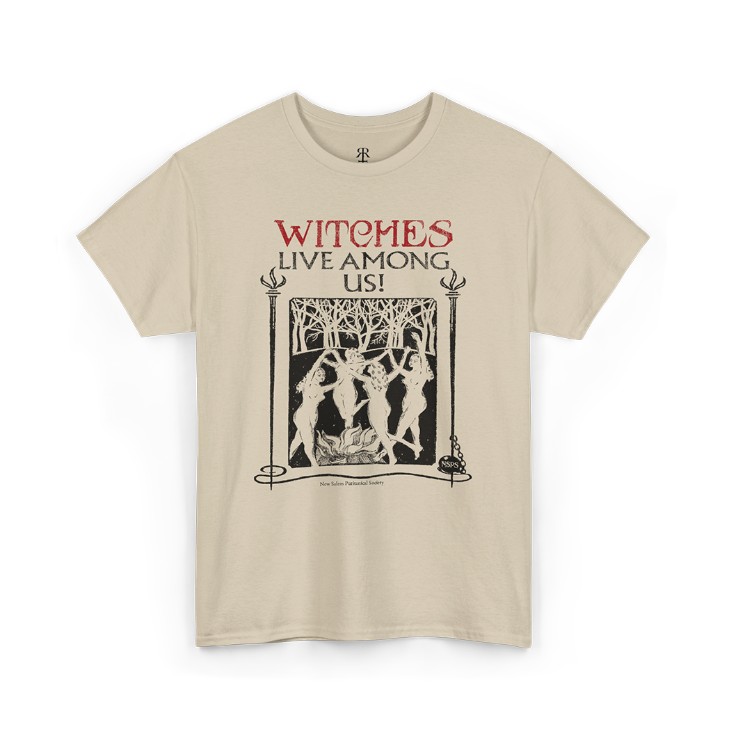 Beige t-shirt with the text 'WITCHES LIVE AMONG US!' and an image of a witch and trees on it.