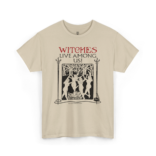 Beige t-shirt with the text 'WITCHES LIVE AMONG US!' and an image of a witch and trees on it.