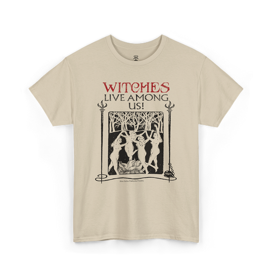 Beige t-shirt with the text 'WITCHES LIVE AMONG US!' and an image of a witch and trees on it.