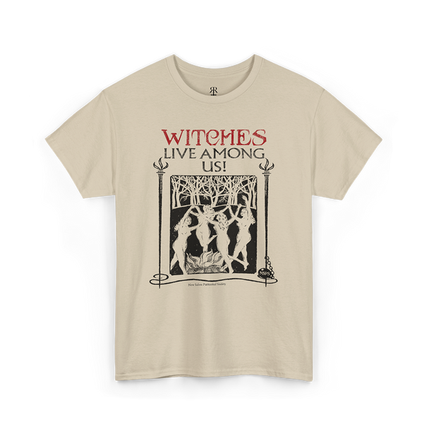Beige t-shirt with the text 'WITCHES LIVE AMONG US!' and an image of a witch and trees on it.