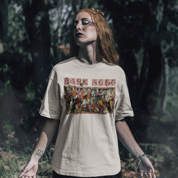 Person wearing a t-shirt with 'Dark Ages' graphic design in a forest setting